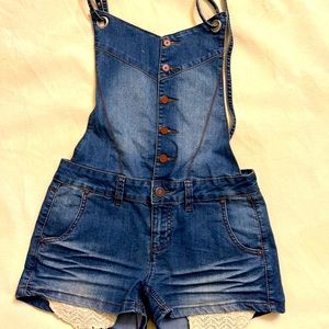 Denim jumper. Front buttons open back adjustable snaps straps. Stretch material